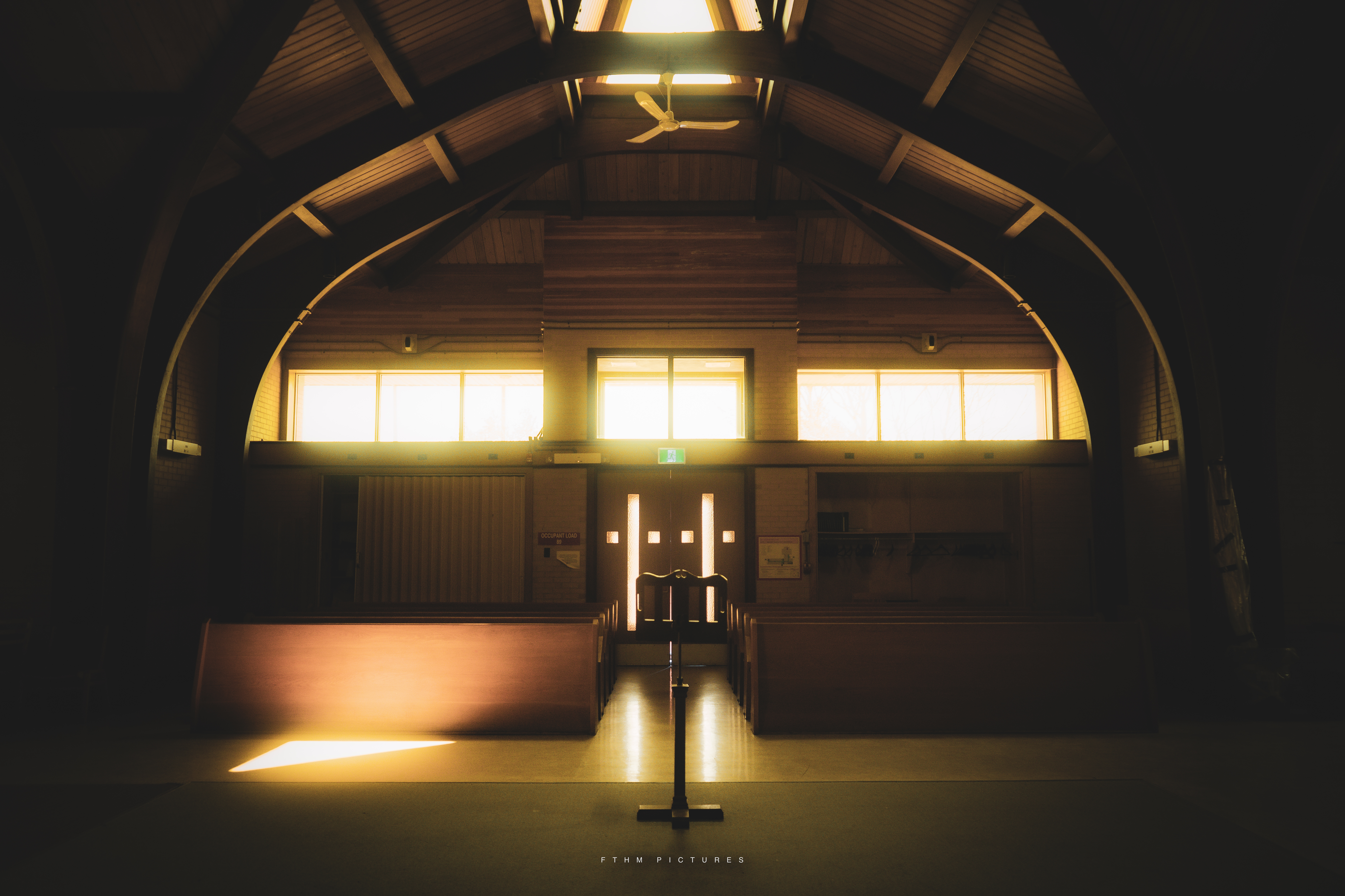 Interior of a wooden church lit by warm evening light